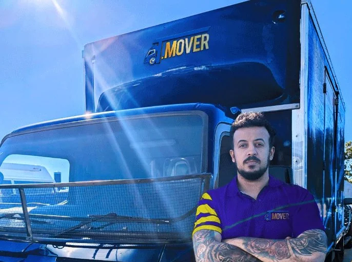 T-MOVERS Mitsubishi Fuso truck with team member ready for Brisbane move